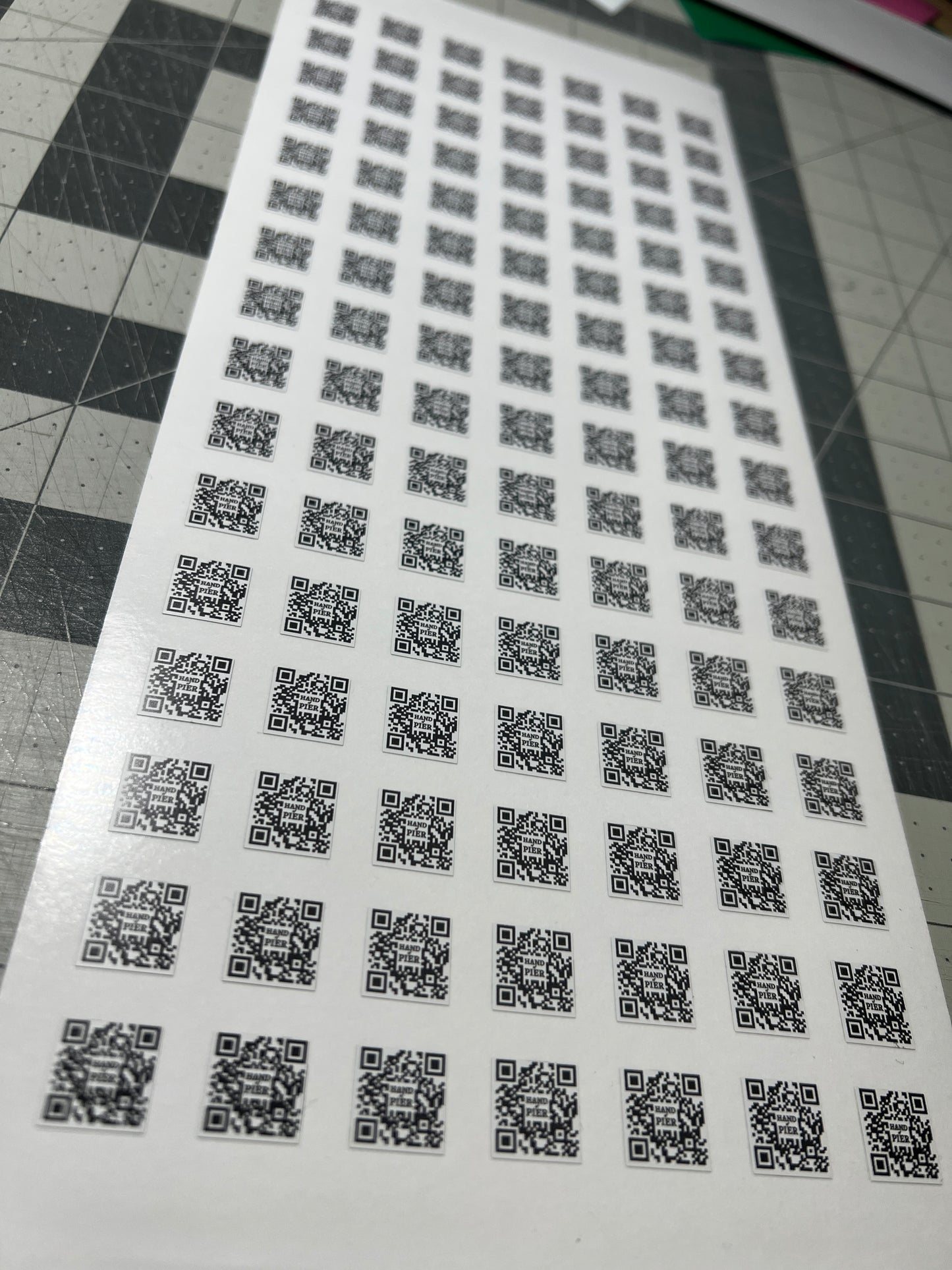 A picture of a sheet of die cut QR codes.