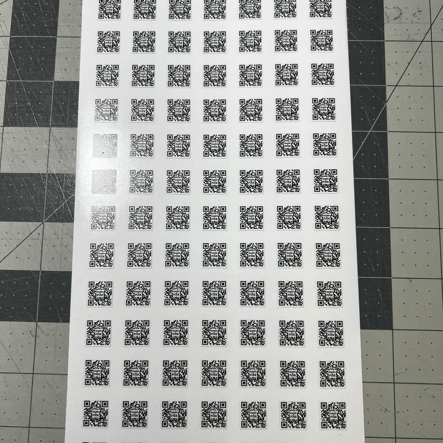 A picture of a sheet of diet cut QR codes.