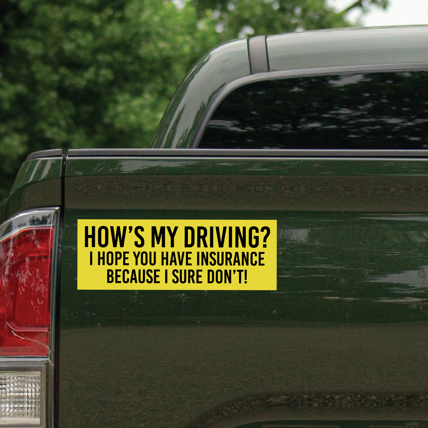 This picture shows a green rear of a truck with a bumper sticker that says, "How's My Driving?" I Hope you have insurance because I sure don't!".
