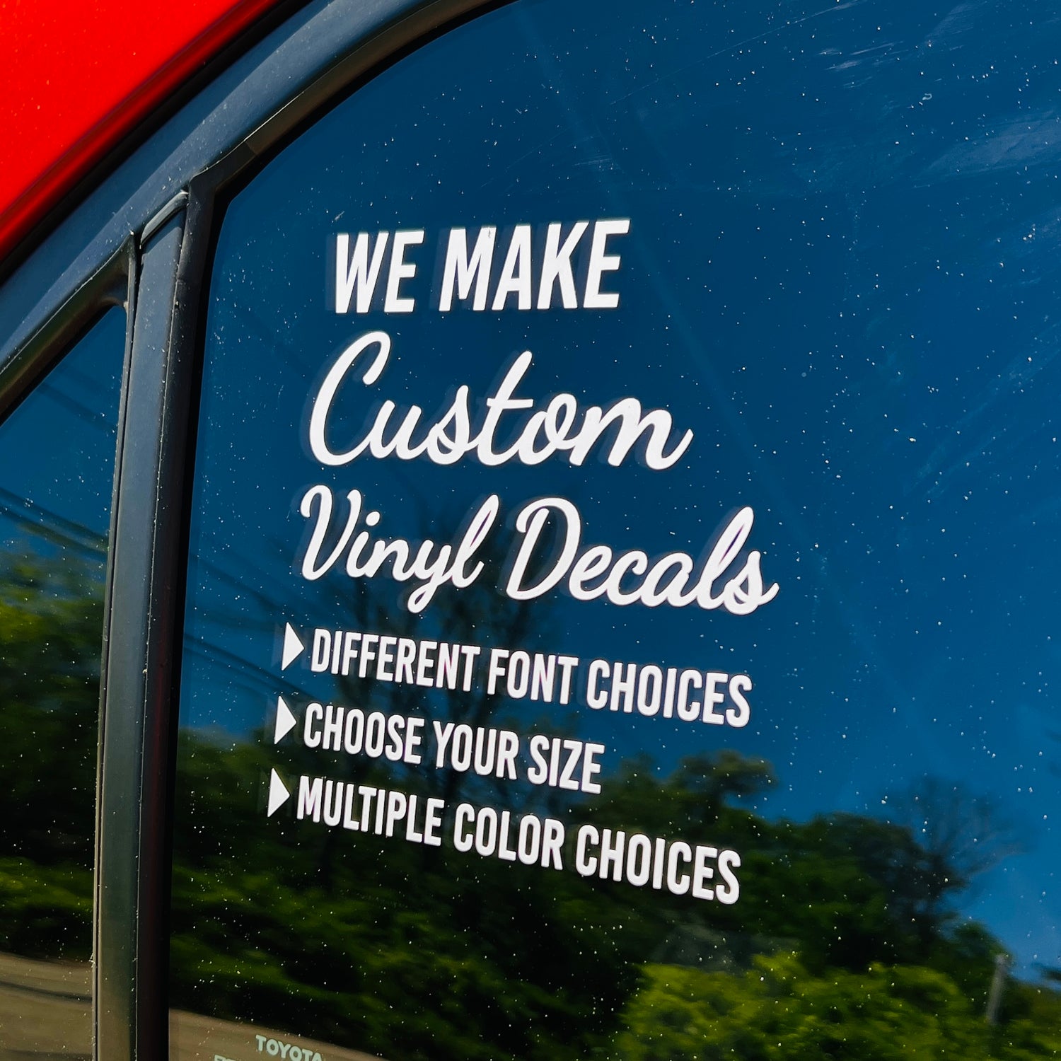 Car window with a custom vinyl decal advertisement for customizable decals.