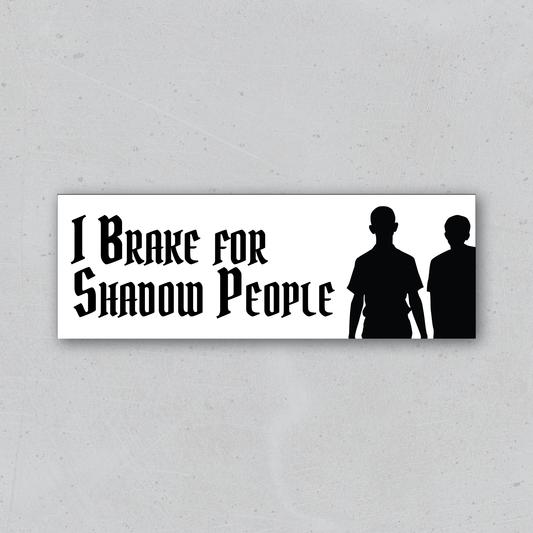 Sticker with 'I Brake for Shadow People' text and silhouettes on a white background
