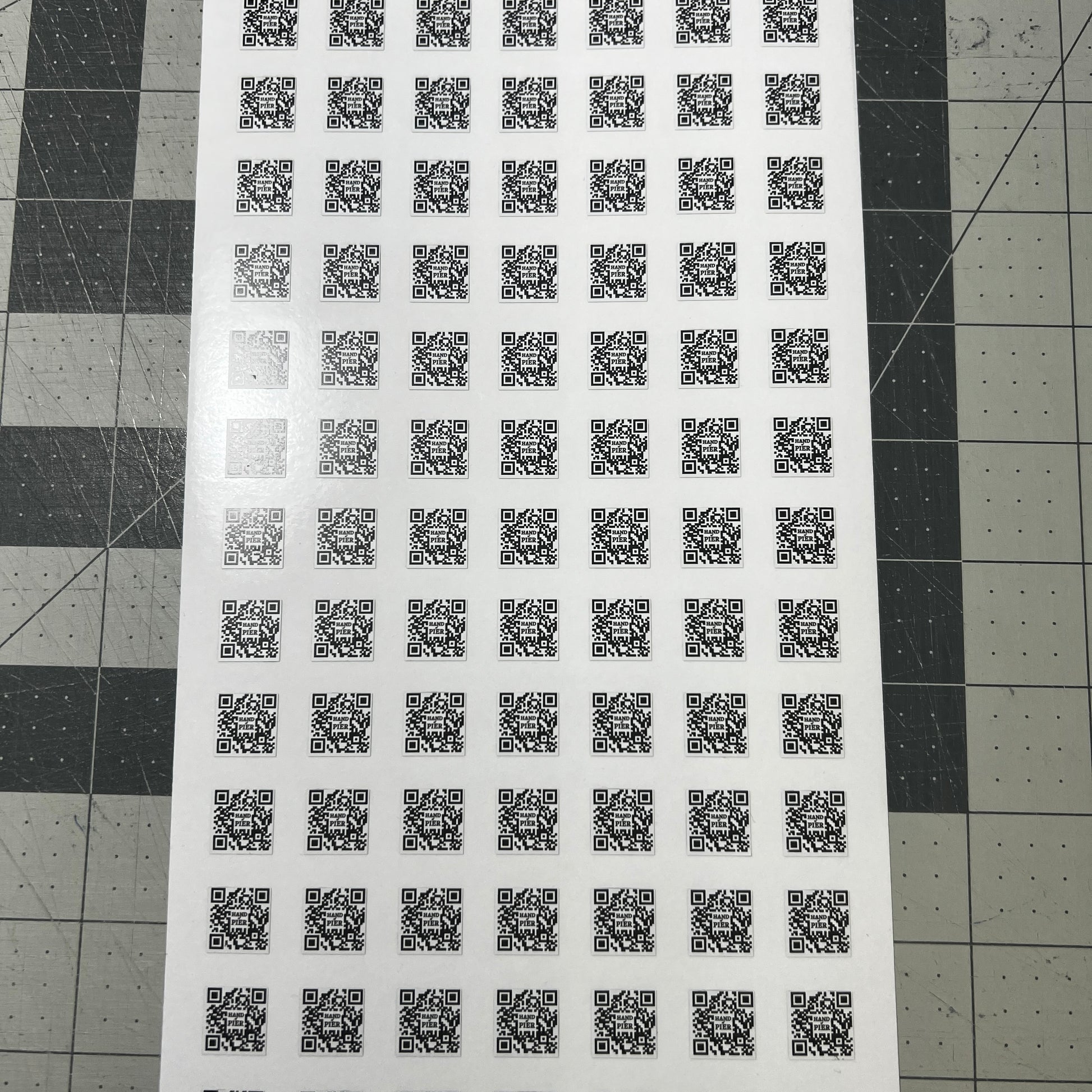 A picture of a sheet of diet cut QR codes.