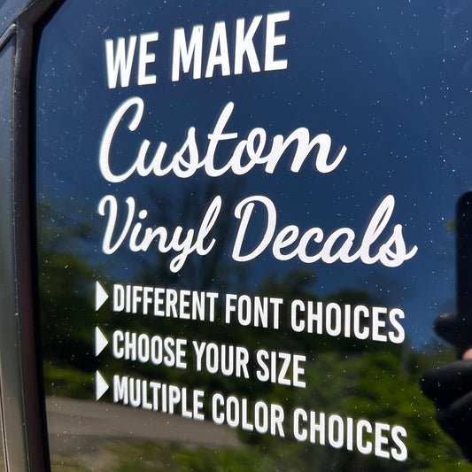 Window with text about custom vinyl decals.