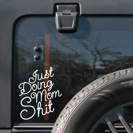 A decal on the back of a Jeep saying "Just Doing Mom Shit".