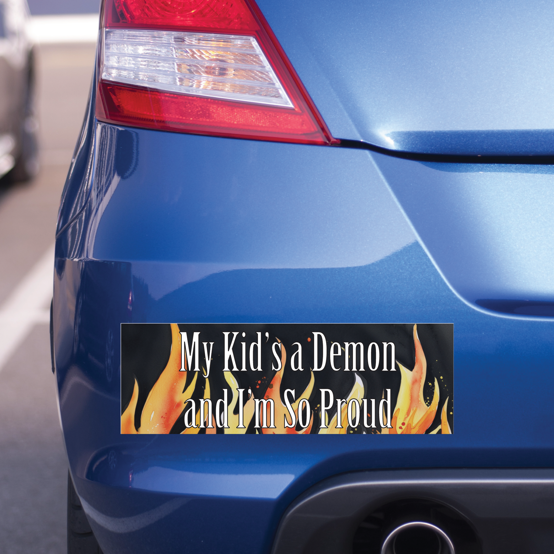 Bumper sticker with text 'My Kid's a Demon and I'm So Proud' on a blue car.