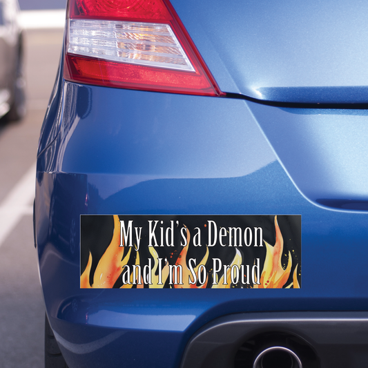 Bumper sticker with text 'My Kid's a Demon and I'm So Proud' on a blue car.