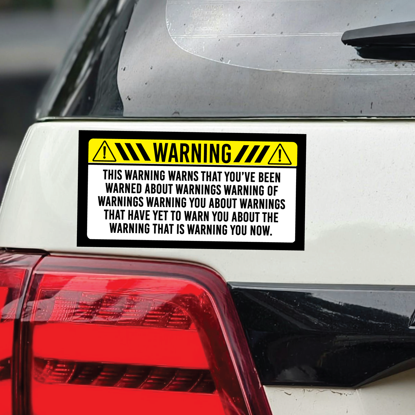 Warning sticker on a car's rear white body surface with humorous text.