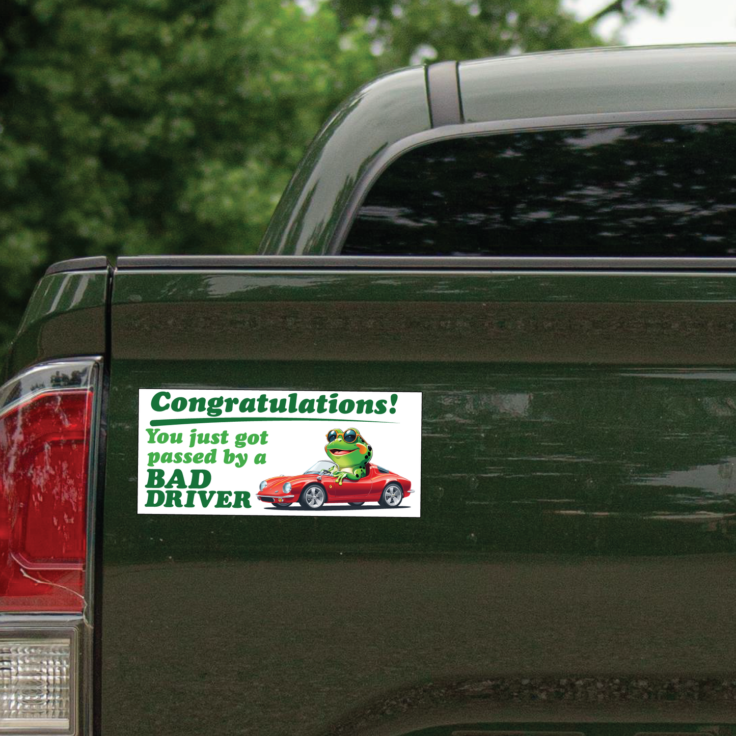 This image showcases the bumper sticker on the rear of a green pick-up truck.