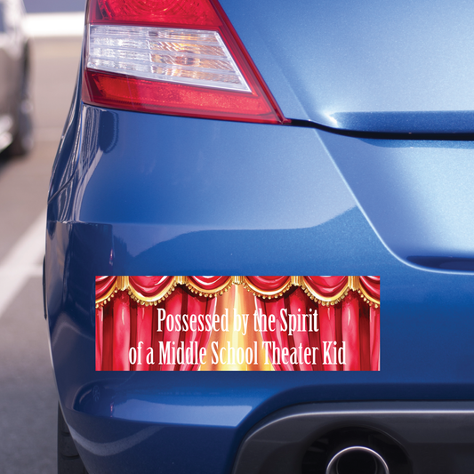 Blue car with a humorous bumper sticker on the back. The text says "Possessed by the Spirit of a Middle School Theater Kid".